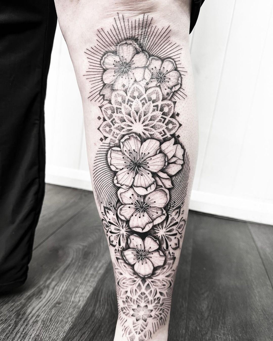 Flowers and mandala leg tattoo by Markings Tattoos