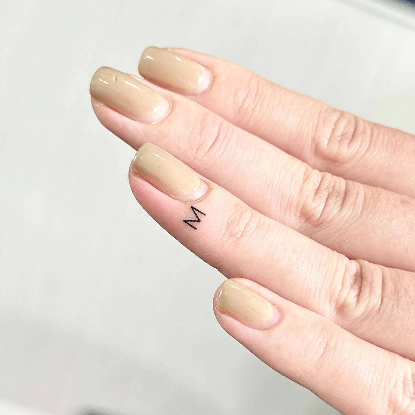 M initials tattoo by Markings Tattoos
