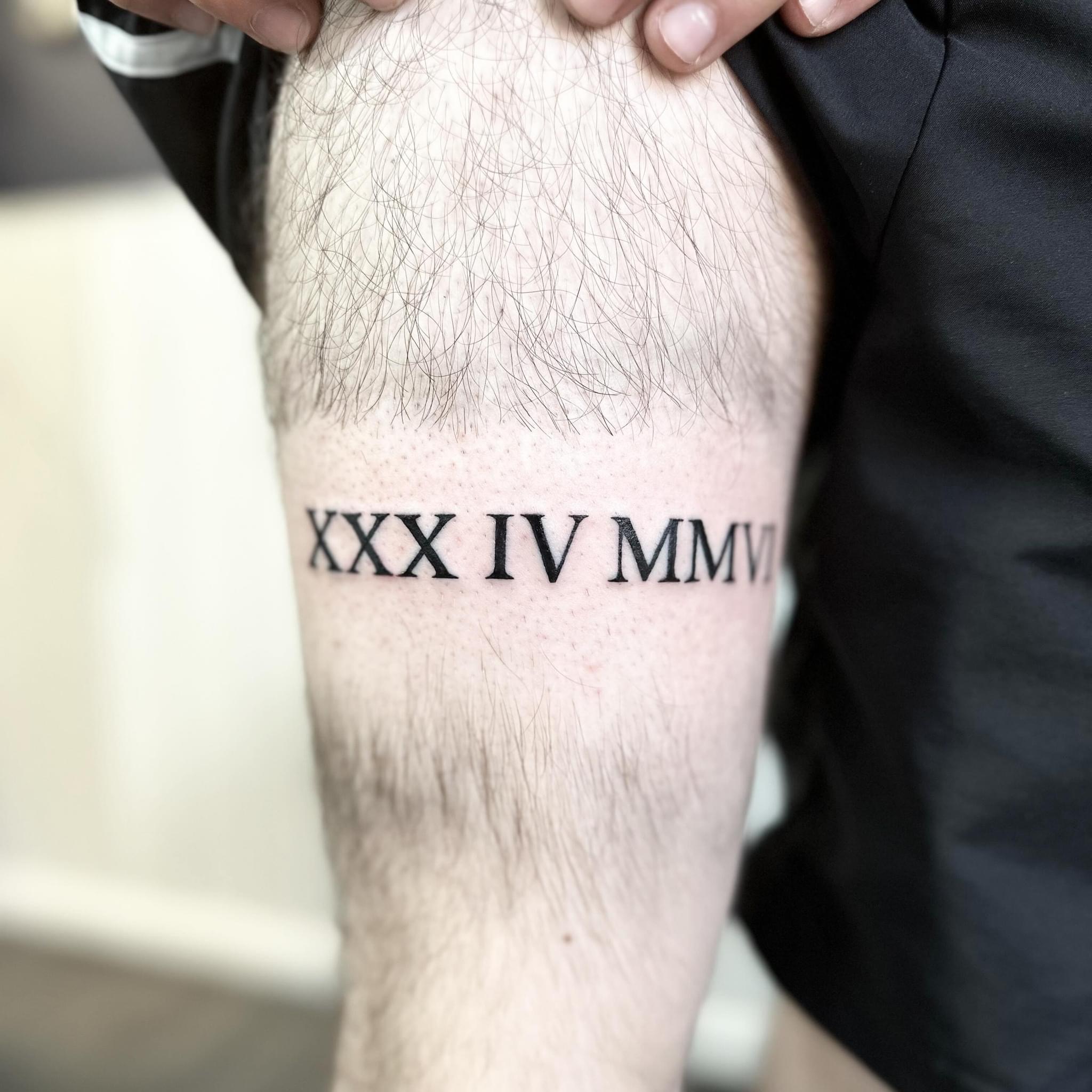 Roman numerals tattoo by Markings Tattoos Hessle