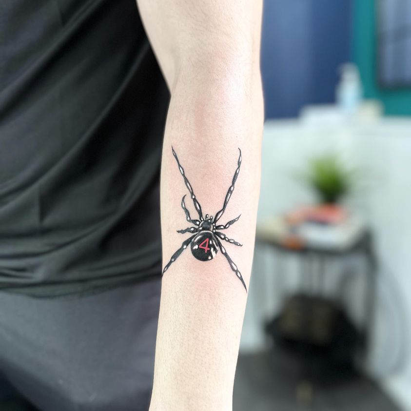 Black widow spider tattoo by Markings Tattoos Hessle
