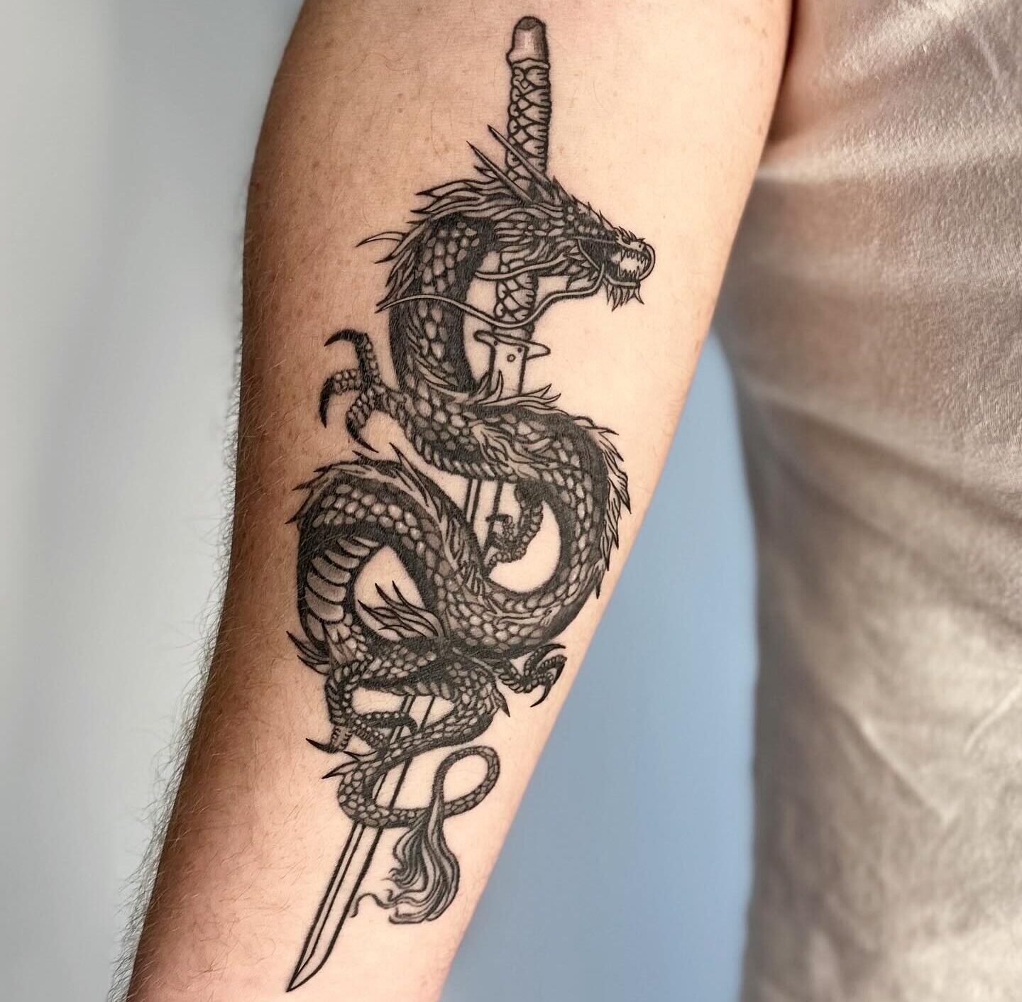 Dragon and samurai sword tattoo by Markings Tattoos